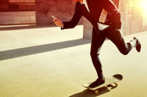 skating while browsing internet on phone - mobile web concept - mobile friendly, mobile first, web on the go