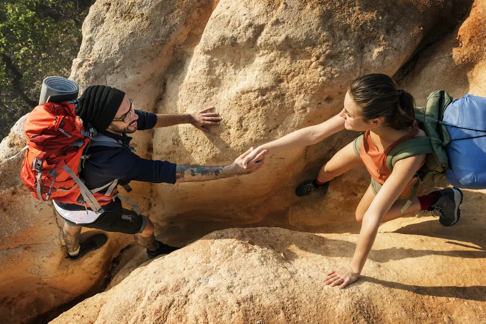 People Hiking Mountain Adventure Concept helping to climb rankings