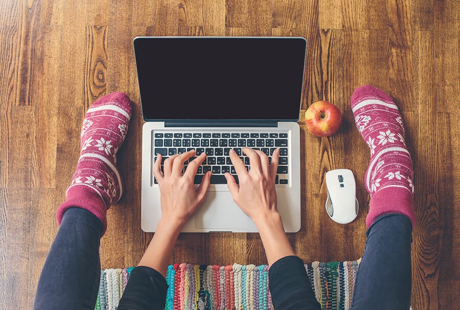 Pink socks, laptop, apple, white mouse on wood floor