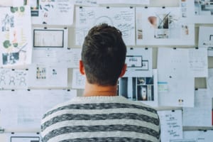 improve marketing - man wearing black and white stripe shirt looking at white 212286