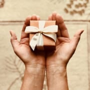 - person s holds brown gift box 842876