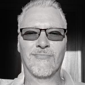 Black and white selfie of man with glasses
