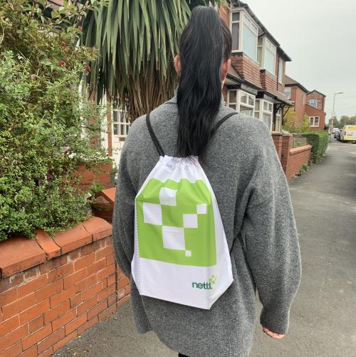 woman wearing branded drawstring backpack