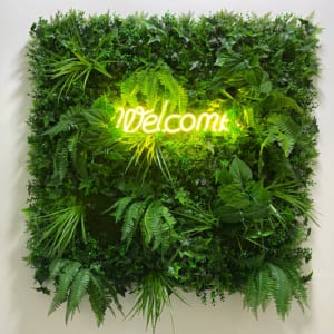 Multiple leaf sign with neon Welcome