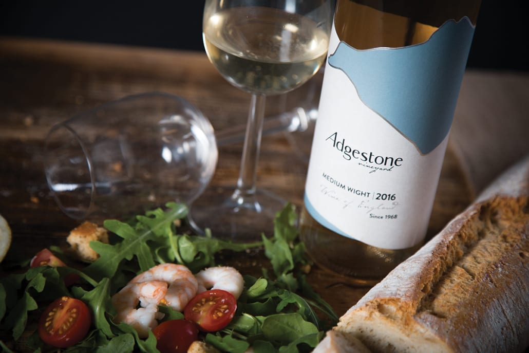 close-up of bread and salad served with white wine in two wine glasses