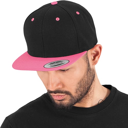 Man wearing black and pink cap