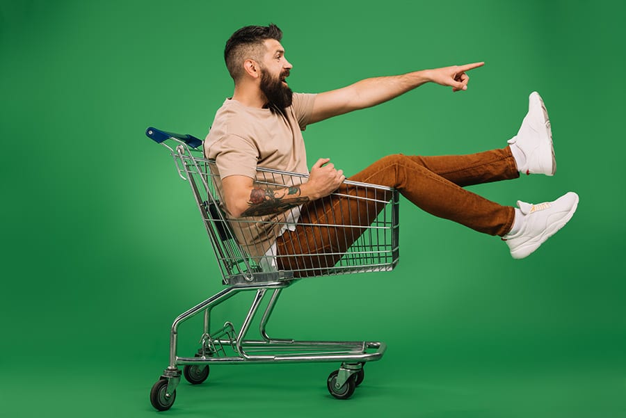 Man sat in trolley with green background