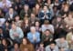 Group of people looking up and clapping