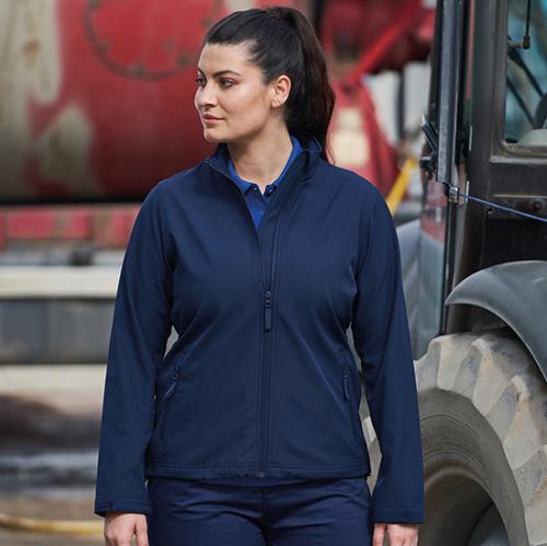 Woman wearing dark blue 2 layer softshell jacket on a building site
