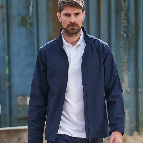 Man wearing dark blue 2 layer softshell jacket on a building site