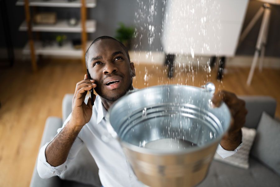 man with water leak searches for roofer or plumber online google search