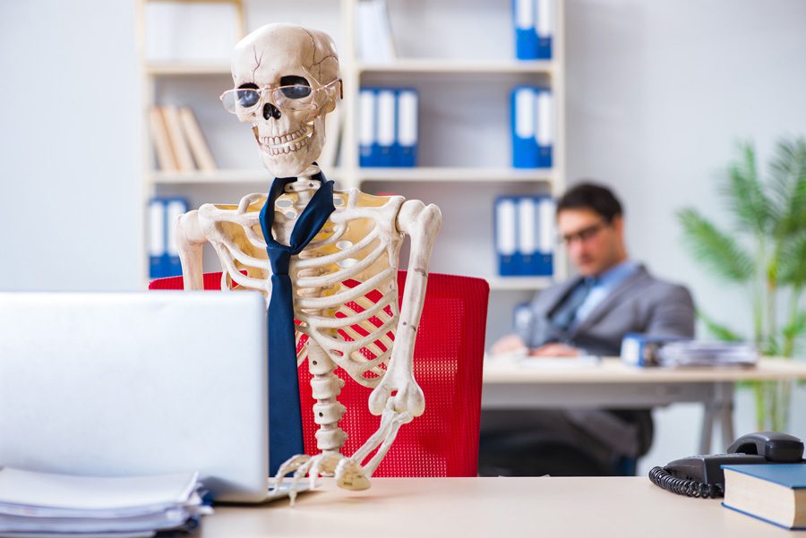 skeleton at desk to ask is seo dead?