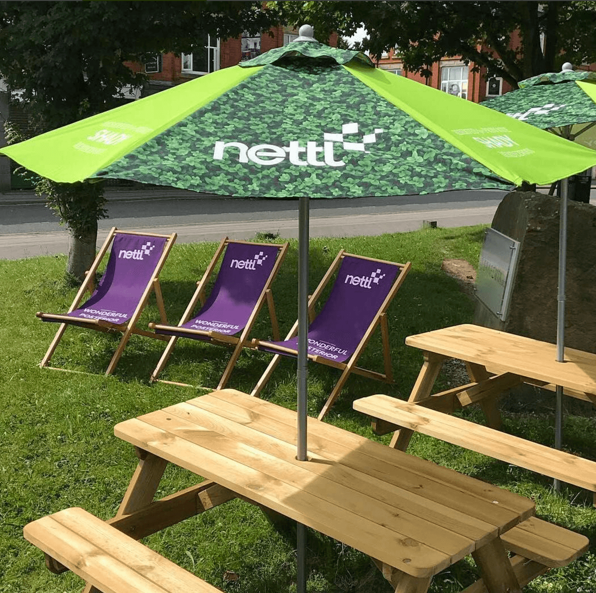 branded parasol umbrella and deckchair outside